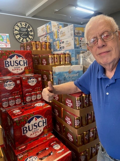 Jack giving a thumbs-up beside beer cases