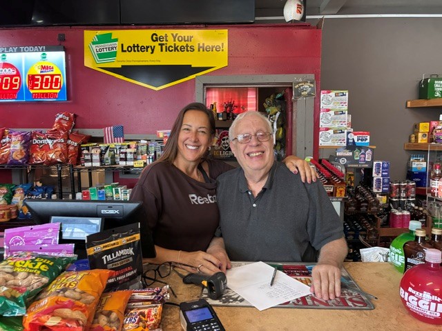 Meg and Jack smiling at the store counter